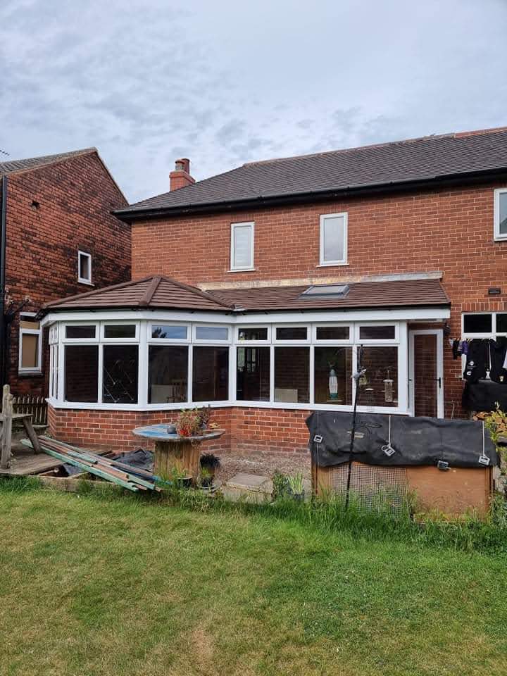 Conservatory tiled warm roof with a roof window
